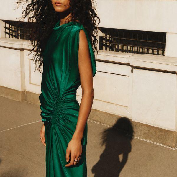 Model in emerald green satin drape dress, A.L.C. spotlight