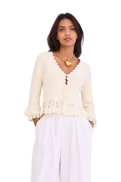 Bunny and Babe Winnetka ivory crochet cardigan with ruffled hem, tiered cuffs, scallop edge neck, and button closure.