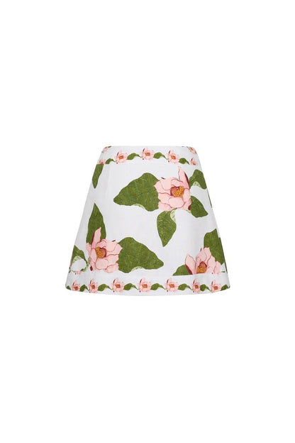 Bunny and Babe Winnetka Fischer mini wrap skirt in ivory linen with pink lotus floral print and green leaves.